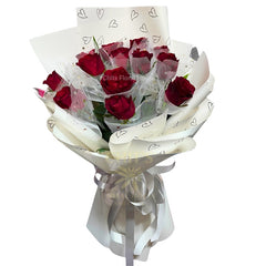 Bouquet of red roses wrapped by chitsfloralhouse