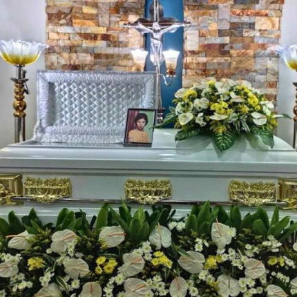 Beautiful funeral casket flower arrangement featuring white anthuriums and yellow chrysanthemums, handcrafted by Chits Floral House for memorial services.