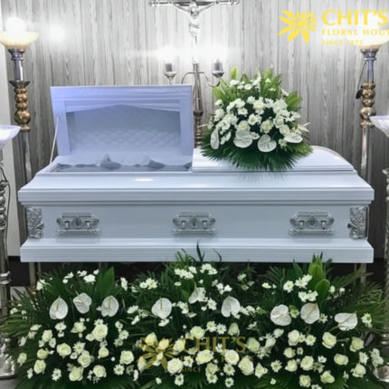 Classic white remembrance casket flower package with white roses, mums, and anthuriums