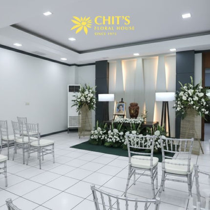 Close-up of white mums and anthurium urn arrangement