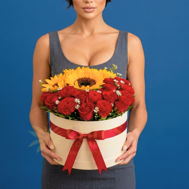 Crimson Sunshine Grandeur with sunflowers red roses carnations and baby’s breath