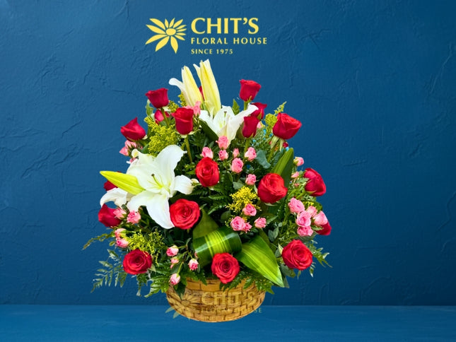 Large Undas floral spray with red roses, white lilies, miniature pink roses and yellow fillers in a basket