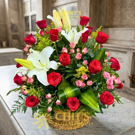 Large Undas floral spray with red roses, white lilies, miniature pink roses and yellow fillers in a basket