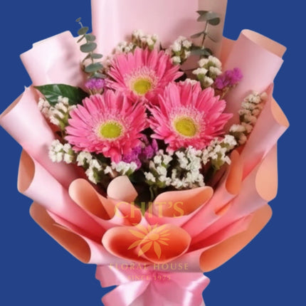 Freshly arranged pink gerbera daisies with imported fillers
