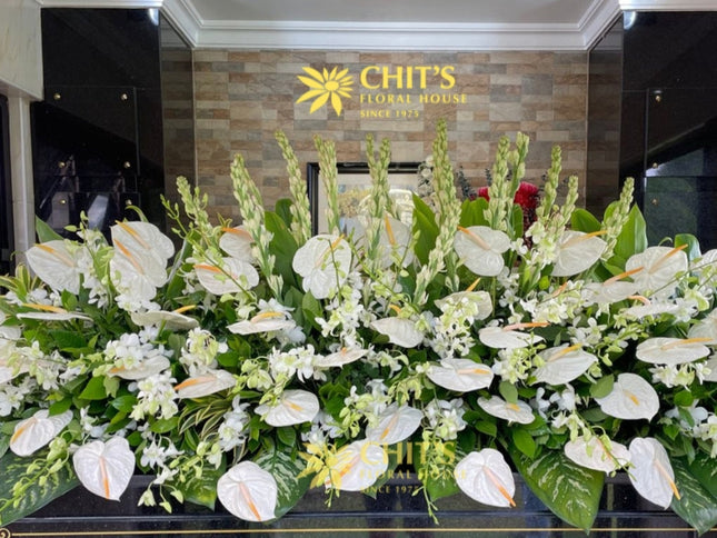 White orchid mausoleum flower arrangement tribute