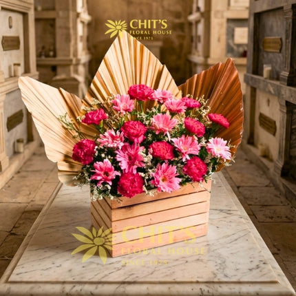 Pink carnation and gerbera Undas memorial flower arrangement in a decorative wooden box