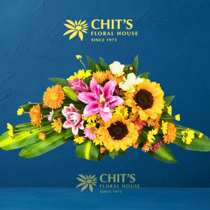 Sunflower and Pink Lily Memorial Lawn Floral Spray