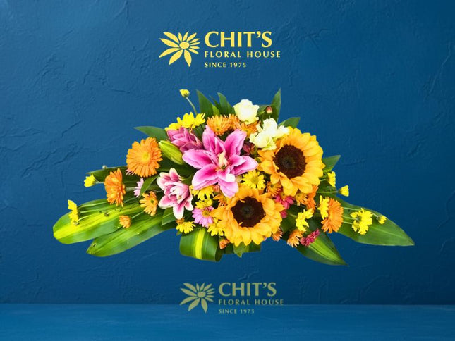 Sunflower and Pink Lily Memorial Lawn Floral Spray