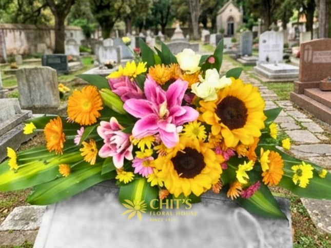 Sunflower and Pink Lily Memorial Lawn Floral Spray