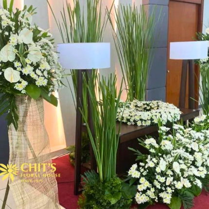 Close-up of white floral urn arrangement with fresh blooms