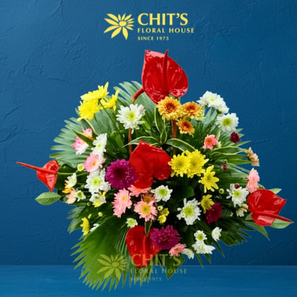 Vibrant Adoration funeral flower basket with red and pink anthuriums