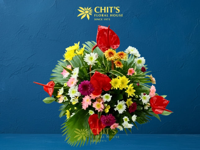 Vibrant Adoration funeral flower basket with red and pink anthuriums