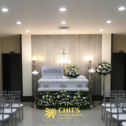 Elegant white casket flower arrangement featuring anthuriums and roses