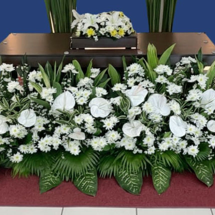 White lilies and yellow mums urn flower arrangement